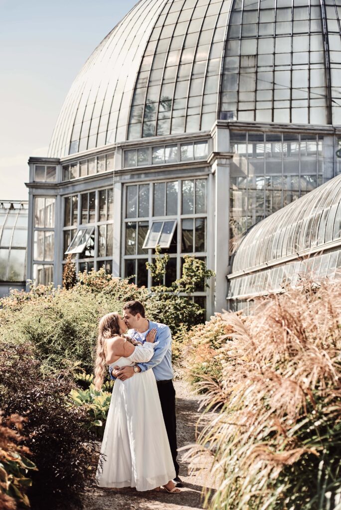 Couple kissing outside of Belle Isle Conservatory on Belle Isle in Detroit, Michigan