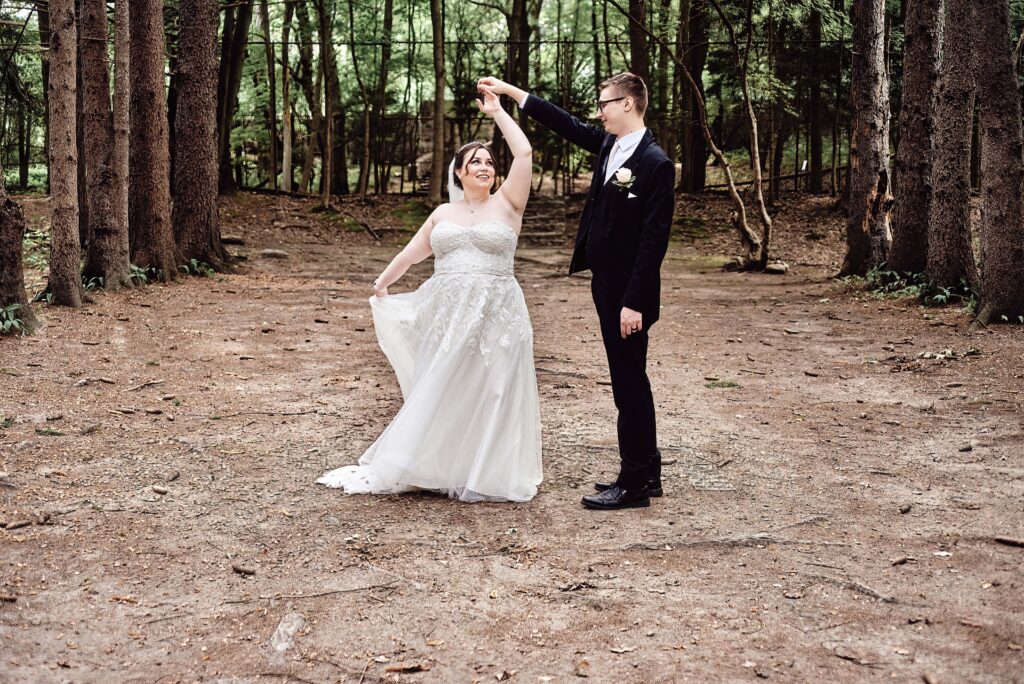 Couple dancing in the tall pine trees at the Sheldon Pines at Stony Creek Metropark in Shelby Township, MI