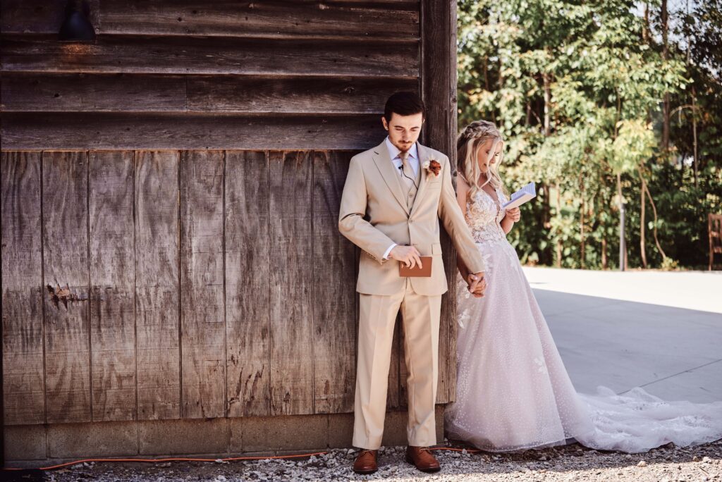 Bride and Groom read their private vows holding hands right before their first look at Celestial Farms in Clio, MI. Photo taken by Erika Black Photography working as a second photographer for Audrey Sytsma Photography