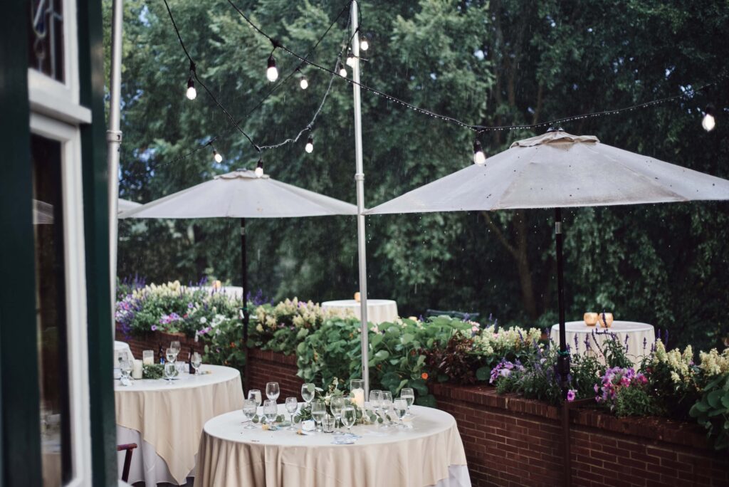 Rain pouring down on abandoned wedding reception tables at a wedding in Kalamazoo, Michigan. Photo taken by Erika Black Photography