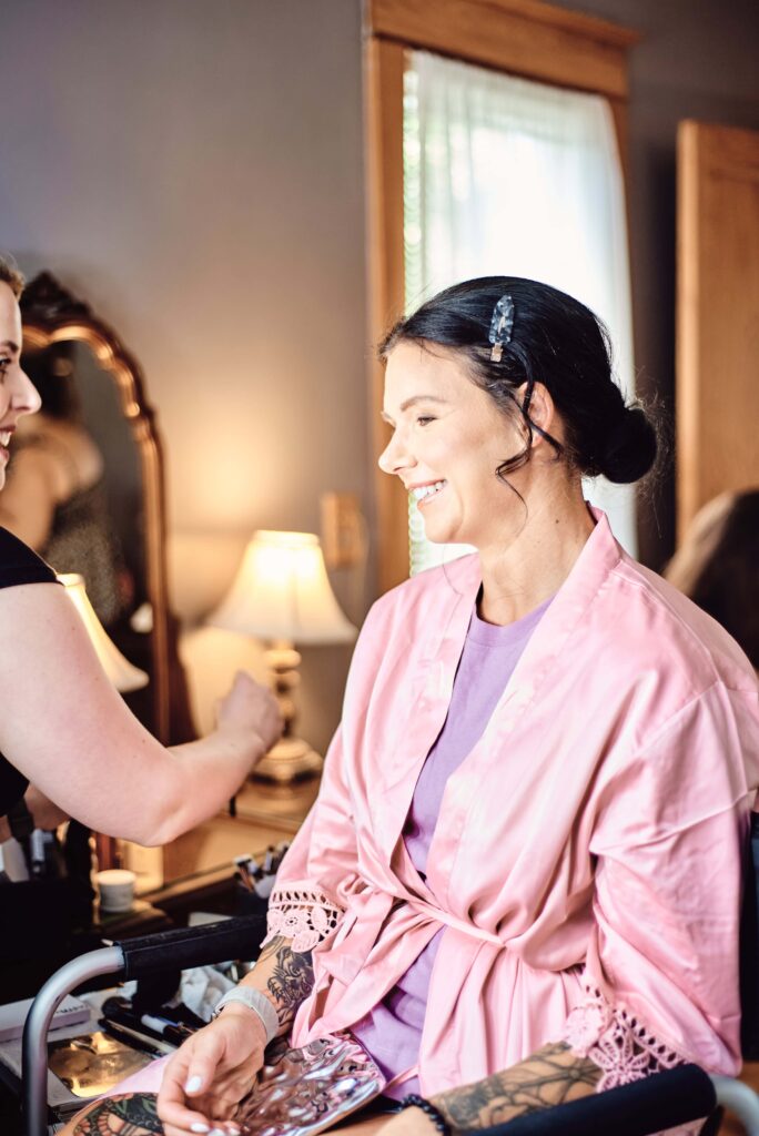 Bridesmaid in pink robe getting her make-up done  at Wellers in Saline, Michigan. Photo taken by 