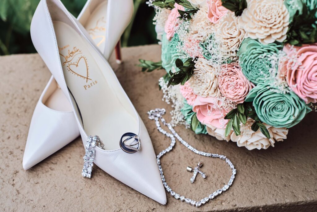 Bridal details. Shoes, jewelry, bride and groom rings, and pink and green bouquet  at Wellers in Saline, Michigan. Photo taken by 