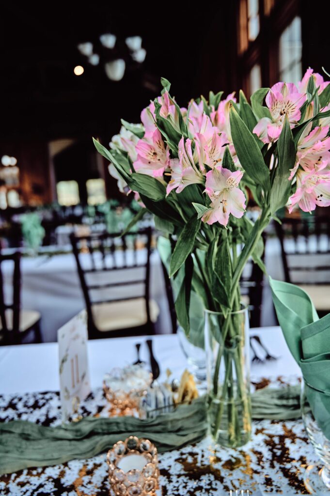 Pink flowers with greenery display on reception tables at Wellers in Saline, Michigan. Photo taken by 