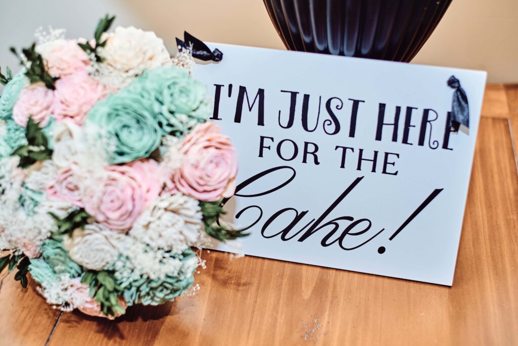 I'm just here for the cake! sign with pink and green bouquet  at Wellers in Saline, Michigan. Photo taken by 