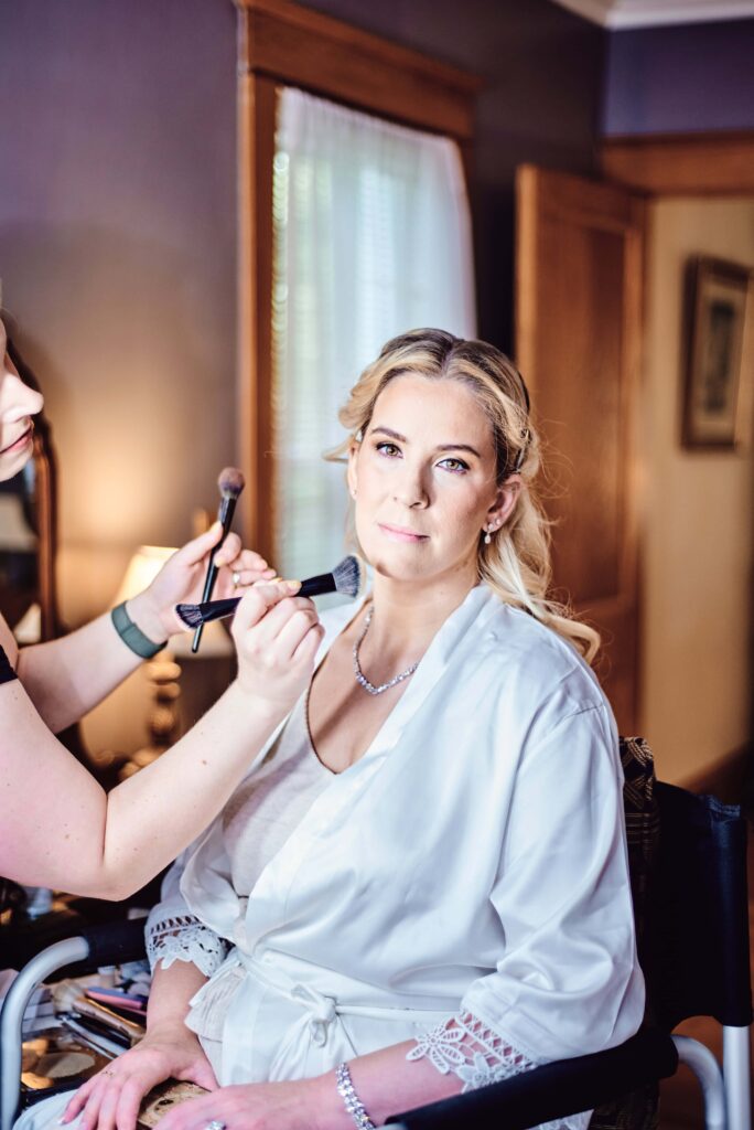 Bride shows off her gorgeous eyes while getting her make-up done  at Wellers in Saline, Michigan. Photo taken by 