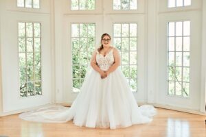 bride stands in wedding dress in the bridal suite of pine knob mansion in clarkston, michigan