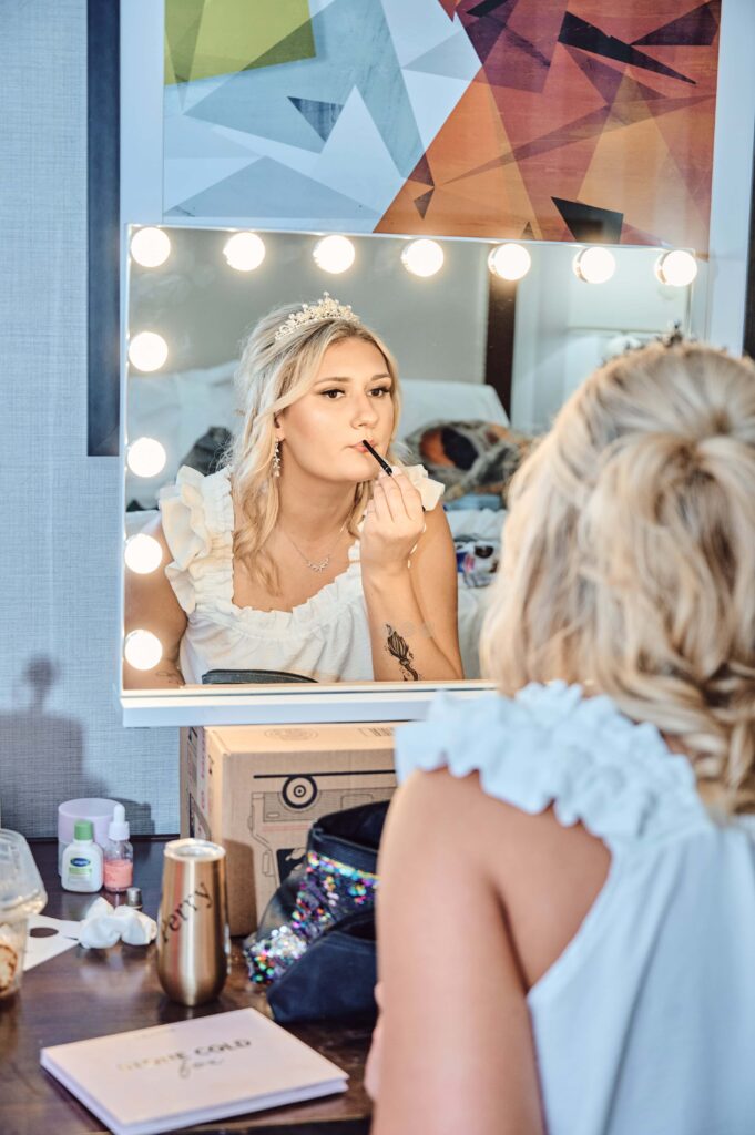Bride doing her make-up at a hotel in Lapeer, Michigan
