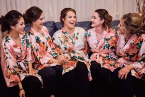 Bride and her bridesmaids hang out together at Silver Shores wedding venue in Wyandotte, Michigan