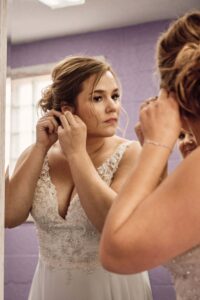 Bride puts her earrings on at Silver Shores wedding venue in Wyandotte, Michigan