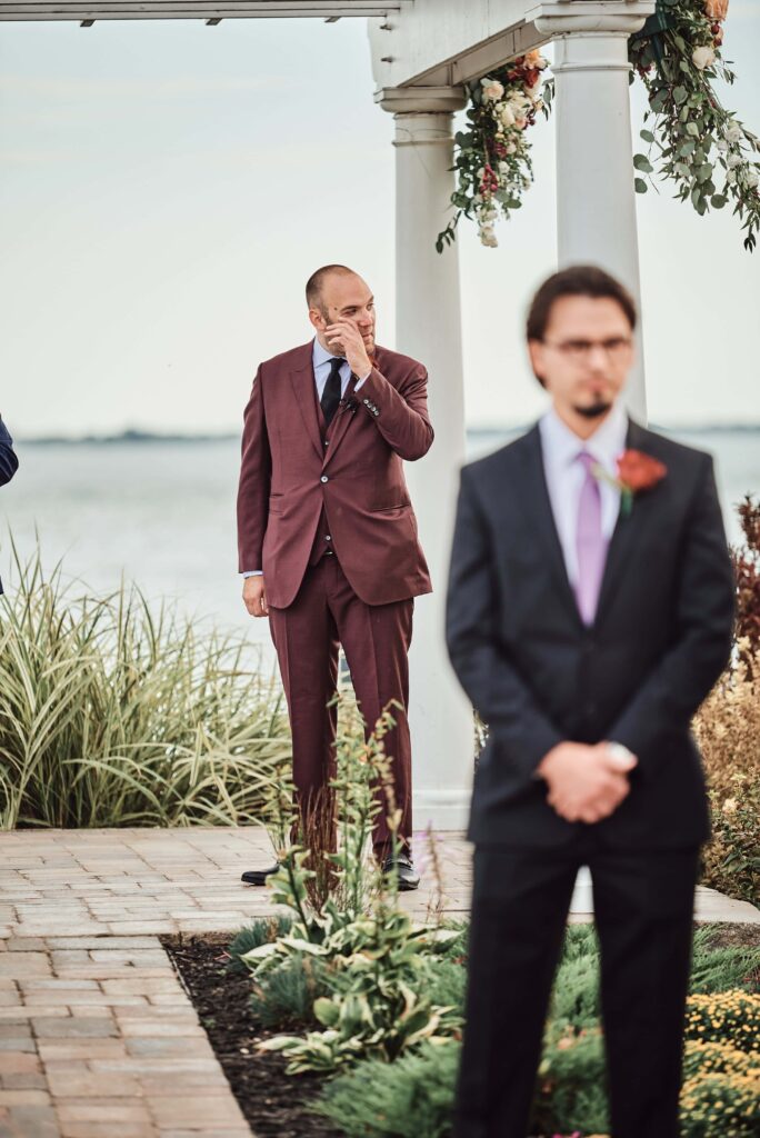 Groom reacts to the bride walking down the aisle at Silver Shores in Wyandotte, Michigan
