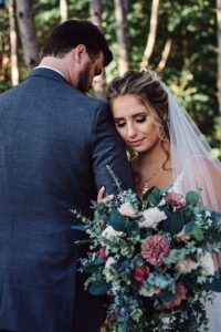 Bride and groom in woods at Sunset Hill Wedding Barn
