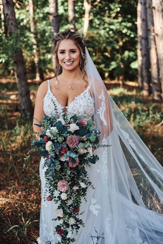 Bride in woods at Sunset Hill Wedding Barn