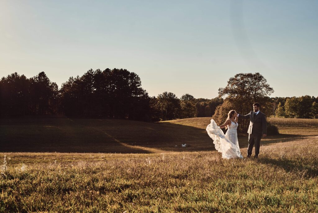 Bride and Groom on hills at Sunset Hill Wedding Barn