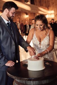Bride and Groom cut their cake at Sunset Hill Wedding Barn