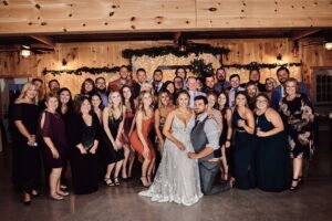 Bride and Groom with large group of friends at Sunset Hill Wedding Barn