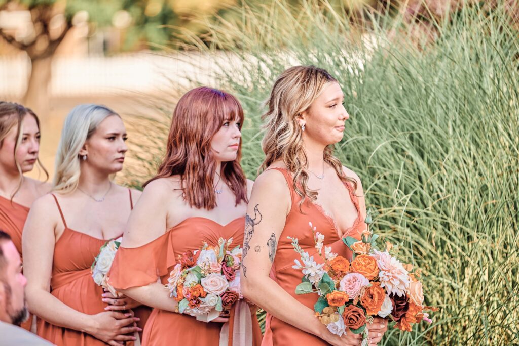 Bridesmaid emotions as they look onto the wedding ceremony at Lapeer Country Club