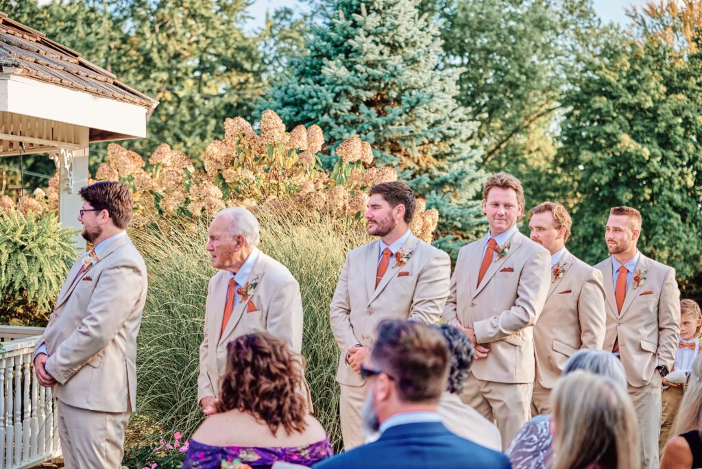 The groomsmen look on as their best friend gets married at Lapeer Country Club