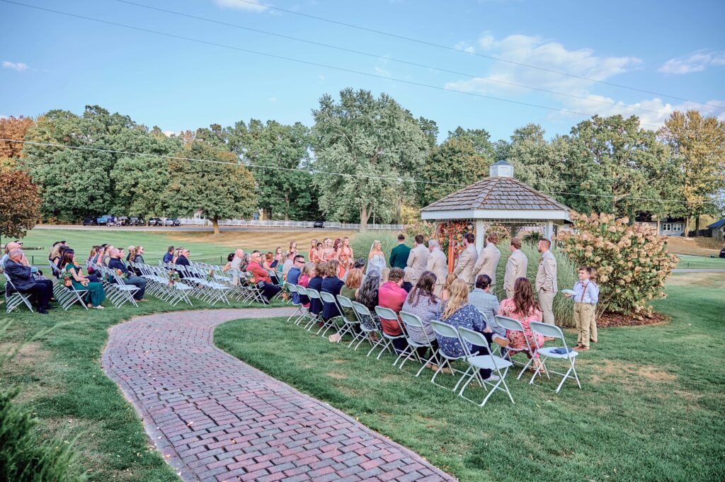 A wide photo of the outdoor ceremony at Lapeer Country Club