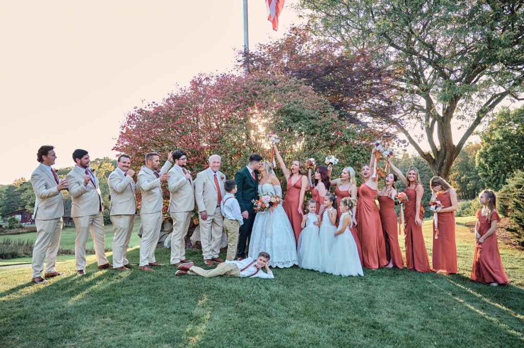 The wedding party celebrates for the bride and groom at sunset at Lapeer Country Club