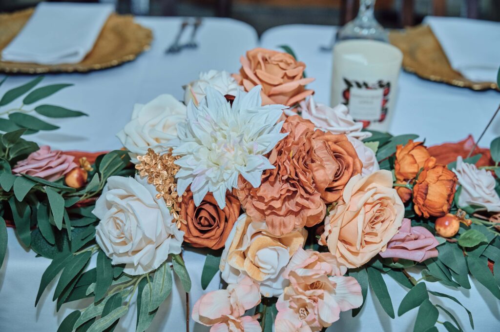 White, orange, and peach flower display at Lapeer Country Club
