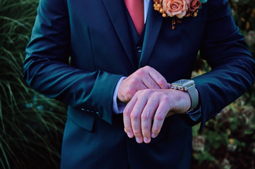 Close up of groom adjusting his wrist watch at Lapeer Country Club