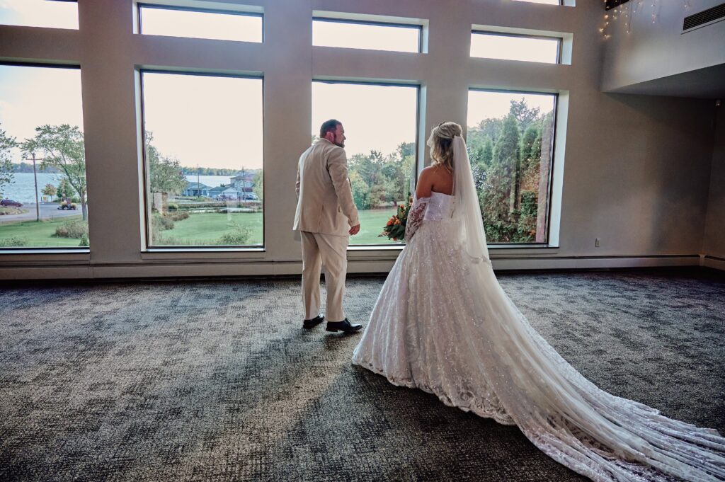 Father of the bride turns to see the reveal of his daughter, the bride, on her wedding day at Lapeer Country Club