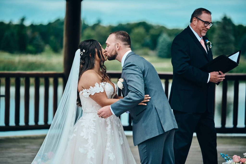 The bride and groom take their first kiss after they say their "I dos"