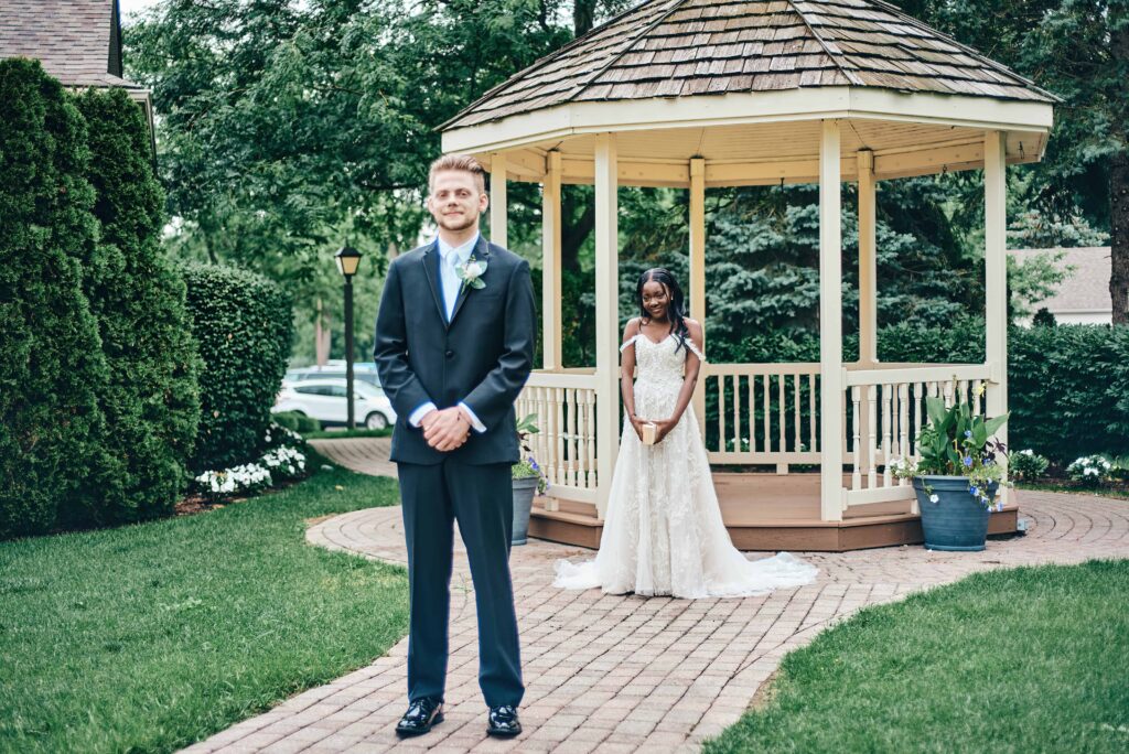A bride and groom are set for their first look before their wedding ceremony
